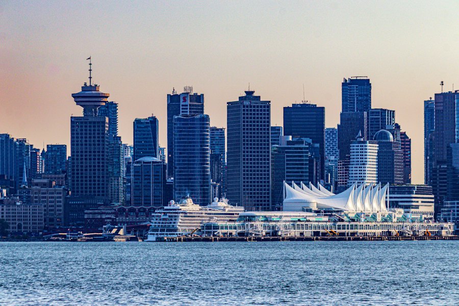 Canada Place's white sails and a cruise ship in front of the downtown skyline