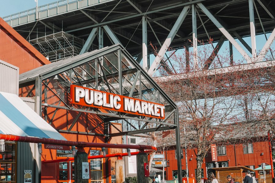 The red Public Market sign at Granville Island under the bridge