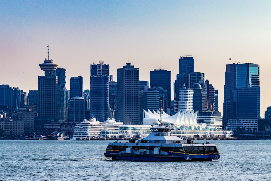 A ferry crossing the harbour in front of the downtown skyline and Canada Place